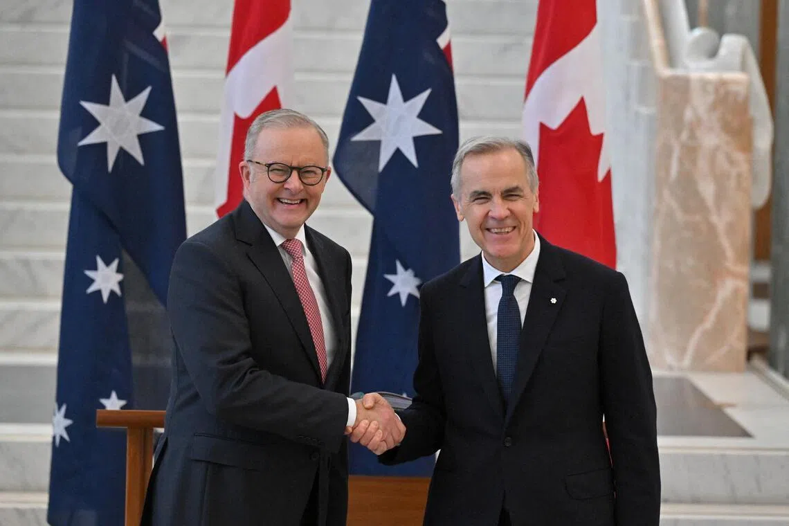 (From left) Australian Prime Minister Anthony Albanese shakes hands with Canada's Prime Minister Mark Carney at the Australian Parliament House, Canberra, Australia, March 5, 2026.