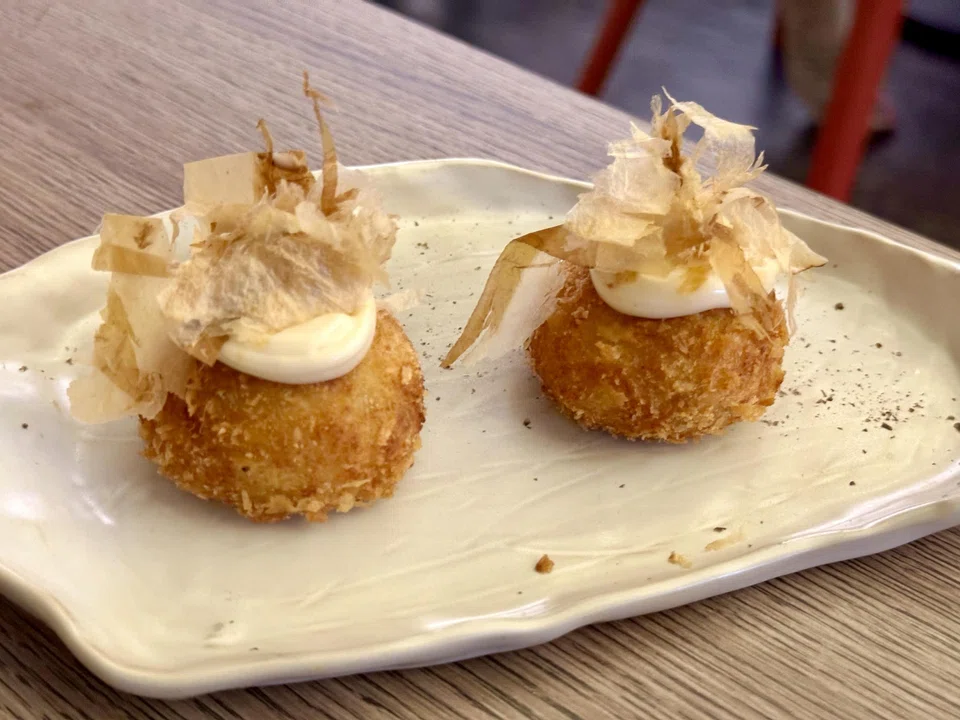 Crab and shrimp croquettes topped with bonito flakes.