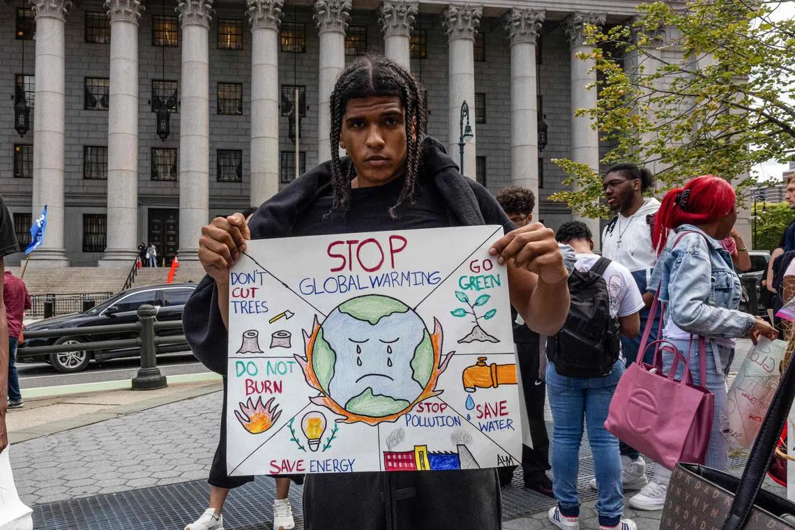 A young climate activist at a demonstration in New York City on Sep 20. Businesses that invest in the next generation through capacity-building and bringing youth to the brainstorming and decision-making table will gain hugely, says the writer. 