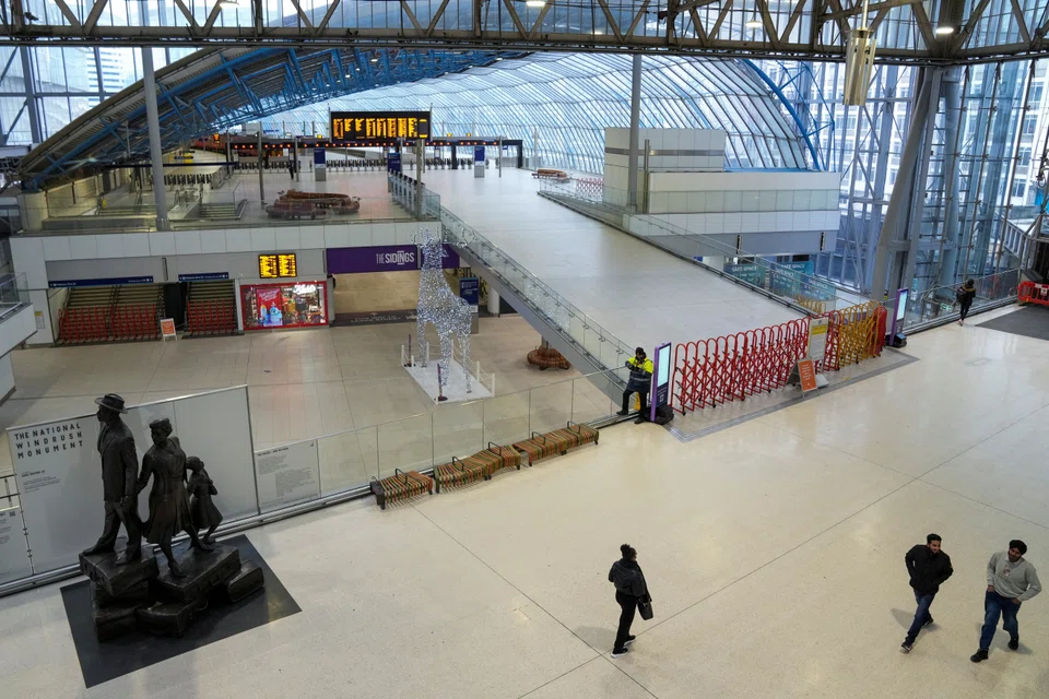 Waterloo Station in London is near empty on Tuesday (Dec 13) as rail workers strike over pay and term, leading thousands of financial professionals to choose to work from home to avoid disrupted commutes.