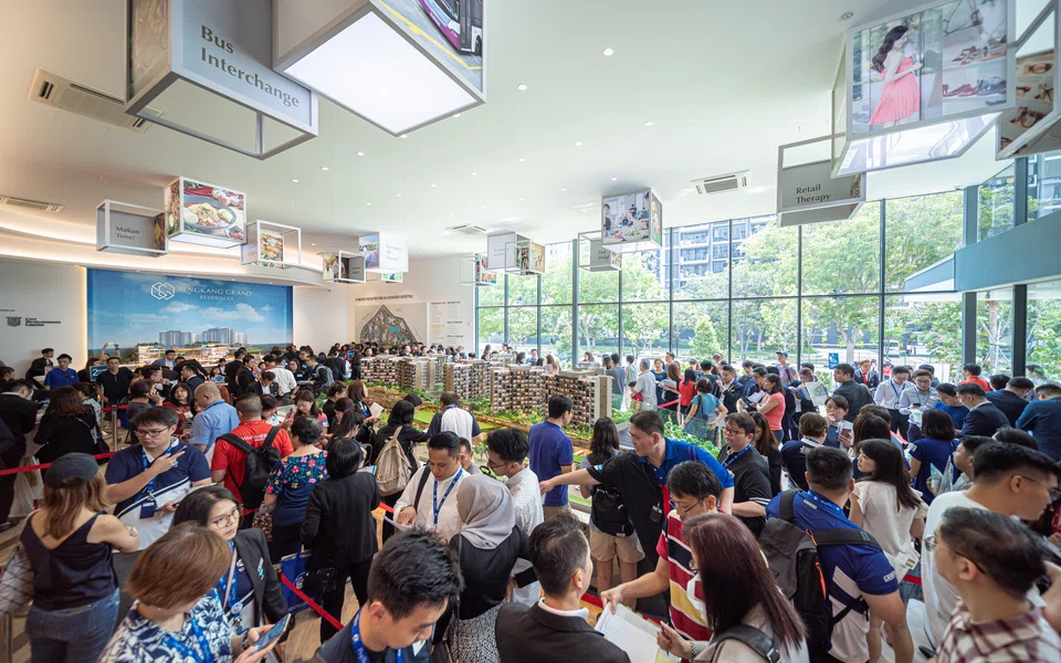 File photo of crowds at a sales gallery. Developers are more likely to appoint agencies to market new projects the higher their headcount. 