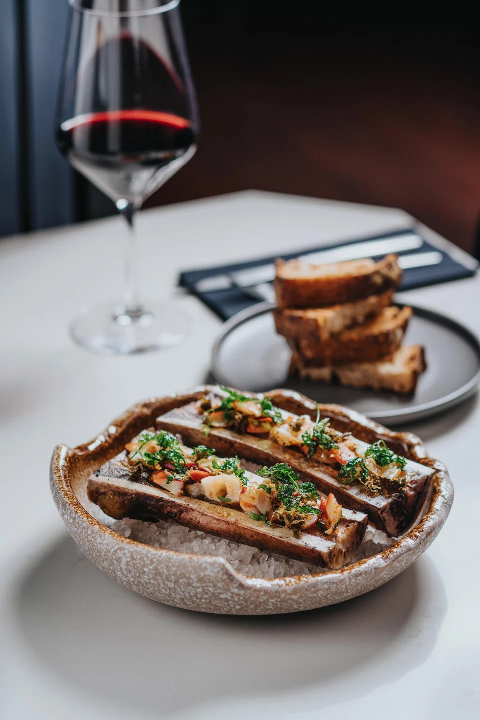 Roasted bone marrow with chopped clams in a garlicky gremolata.