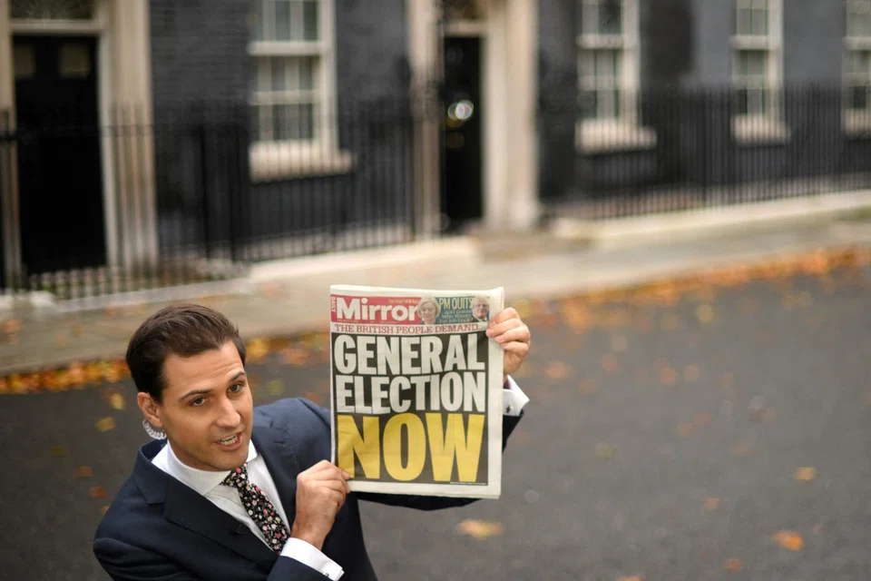 A journalist reporting from outside 10 Downing Street in  London on Oct 21.  Whoever becomes the UK’s next leader will have to deal with an economy that is in a critical state. 