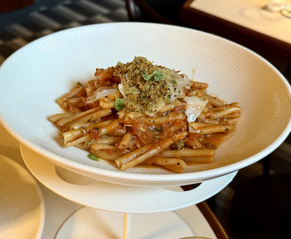 Casarecce pasta in tomato sauce with crabmeat and shrimp.