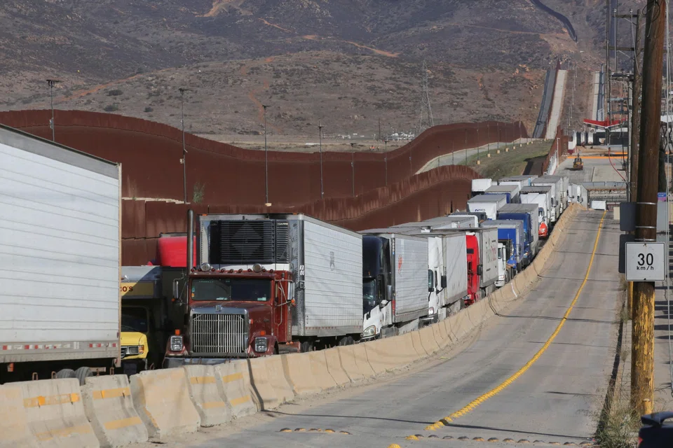 Trailer trucks in Tijuana queuing to cross into the US. Trump’s decision to impose a 25% tariff on Mexican goods will almost certainly push Mexico into a recession, driving more migration northward.