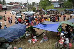 People gather to receive aid at a temporary camp amid clashes along the Cambodia-Thailand border in Siem Reap, Cambodia, Dec 10, 2025. 