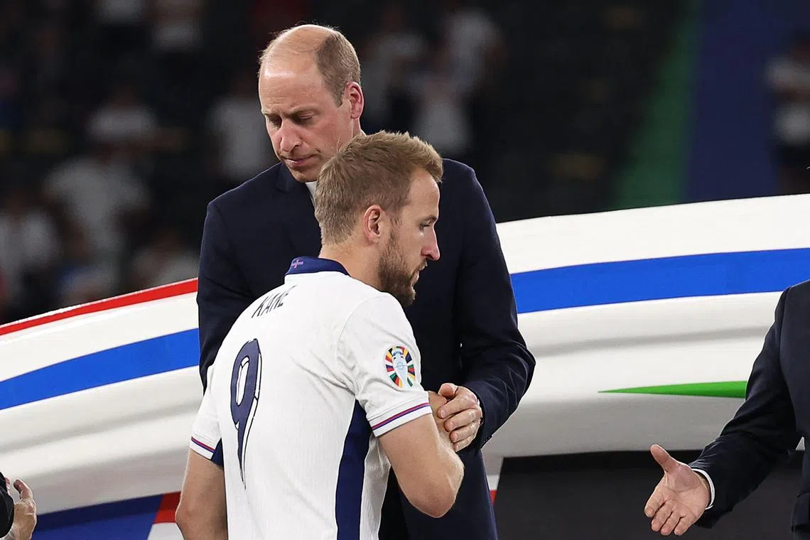 England's Harry Kane is consoled by Britain's Prince William after the Uefa Euro 2024 final football match between Spain and England in Berlin, Germany, July 14, 2024. 