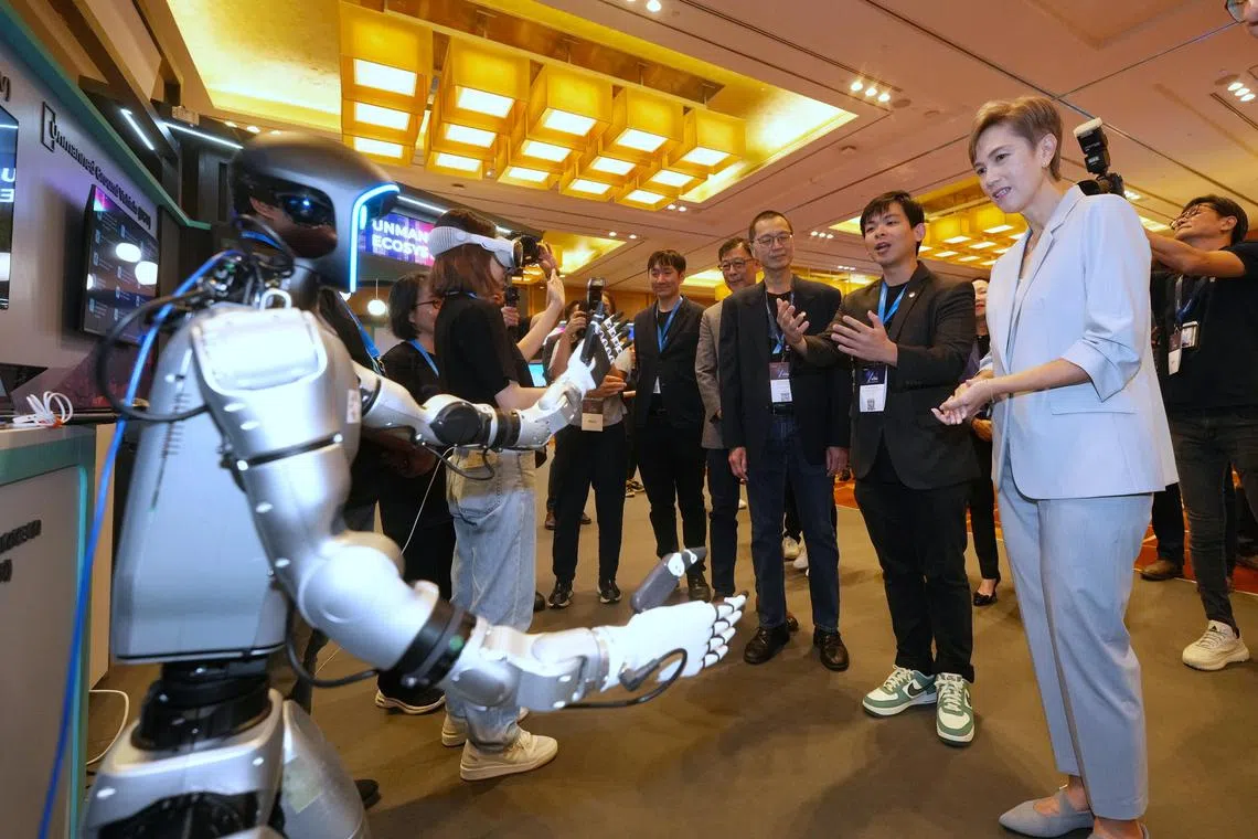 Minister for Digital Development and Information Josephine Teo (first from right) touring Mumtos at ST Engineering's InnoTech Conference on Sep 4. She noted the need for people to acquire AI-related skills.