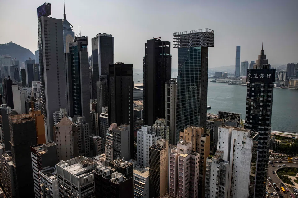 Commercial and residential buildings are seen in Hong Kong on September 15, 2022. - The amount of vacant top-tier office space has more than doubled in Hong Kong over the last three years as companies downsize operations, researchers have found, warning that demand could remain soft even if pandemic controls are lifted. (Photo by ISAAC LAWRENCE / AFP)