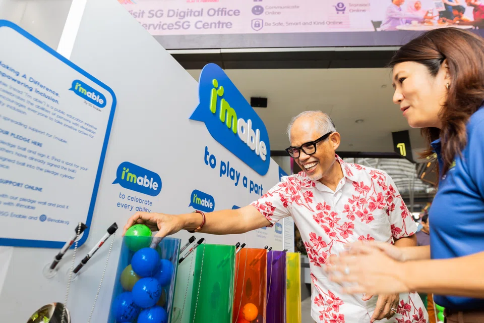 Minister for Social and Family Development Masagos Zulkifli with an SG Enable staff member at Volunteer Festival 2024 on Sunday.
