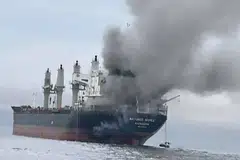 A Thai-flagged bulk carrier, was set ablaze, forcing the evacuation of crew, with three people reported missing and believed trapped in the engine room.