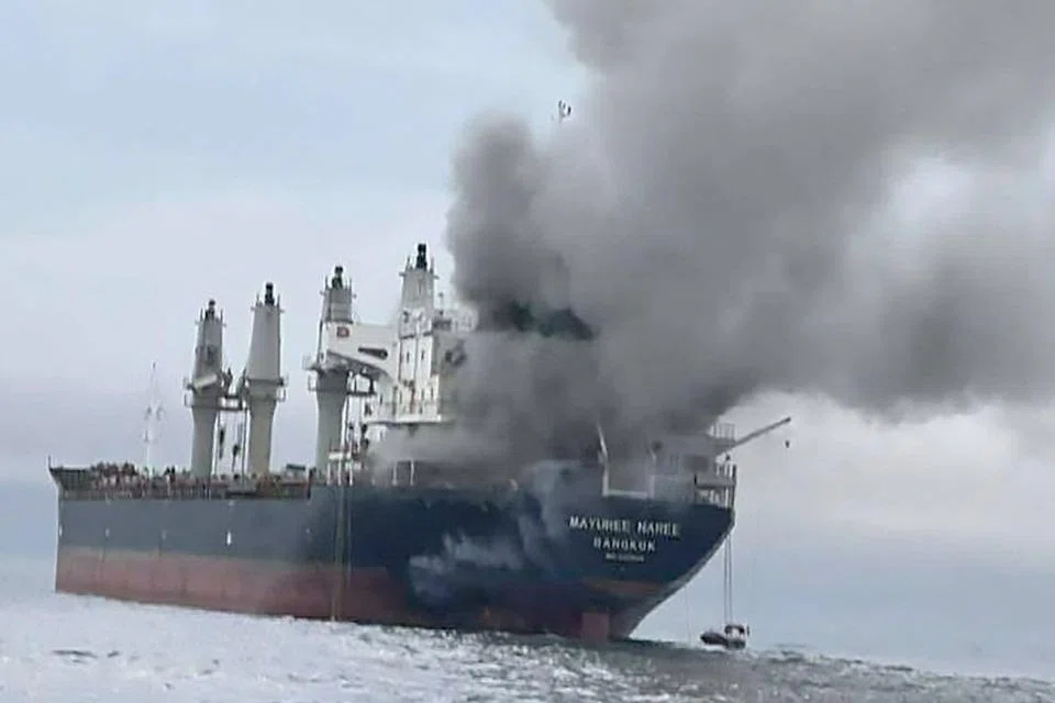 A Thai-flagged bulk carrier, was set ablaze, forcing the evacuation of crew, with three people reported missing and believed trapped in the engine room.