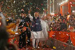 India’s Prime Minister Narendra Modi (C) flashes a victory sign as he arrives at the BJP headquarters to celebrate the party’s win in New Delhi. Modi’s BJP won 240 seats on its own, a weakened verdict which could slow India’s fiscal tightening, ratings agency Moody’s warned.