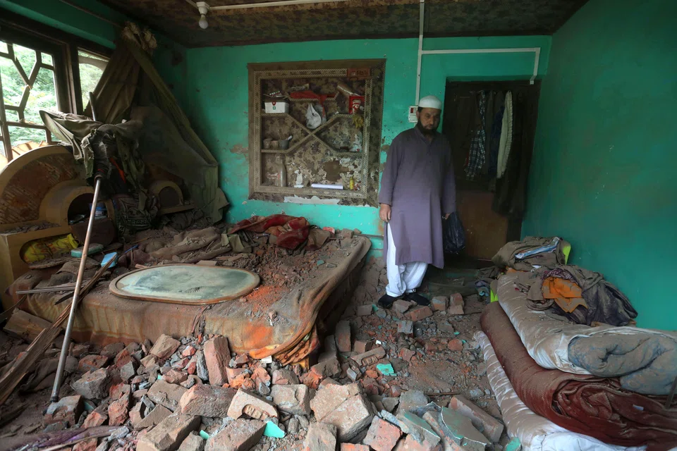 A Kashmiri villager inspects a house damaged after cross-border shelling from Pakistan, at Gingal village in Uri, India-administered Kashmir, May 9, 2025. 