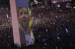 Argentina fans celebrate winning the Fifa World Cup at the Obelisk in Buenos Aires with an image of team captain Lionel Messi.