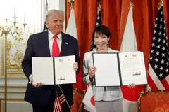 US President Donald Trump and Japanese Prime Minister Sanae Takaichi at a ceremony signing a document to implement the US–Japan trade agreement.