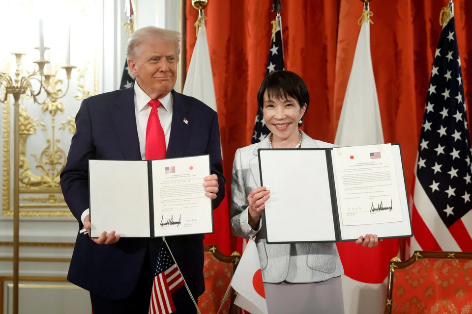 US President Donald Trump and Japanese Prime Minister Sanae Takaichi at a ceremony signing a document to implement the US–Japan trade agreement.