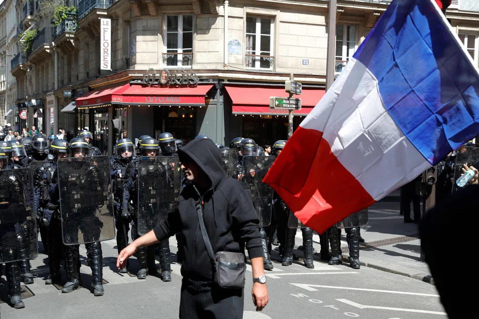 A taxi driver waves a French flag during a rally as part of a nationwide demonstration against proposed changes in how the state finances medical transport services, Paris, France, May 19, 2025 .