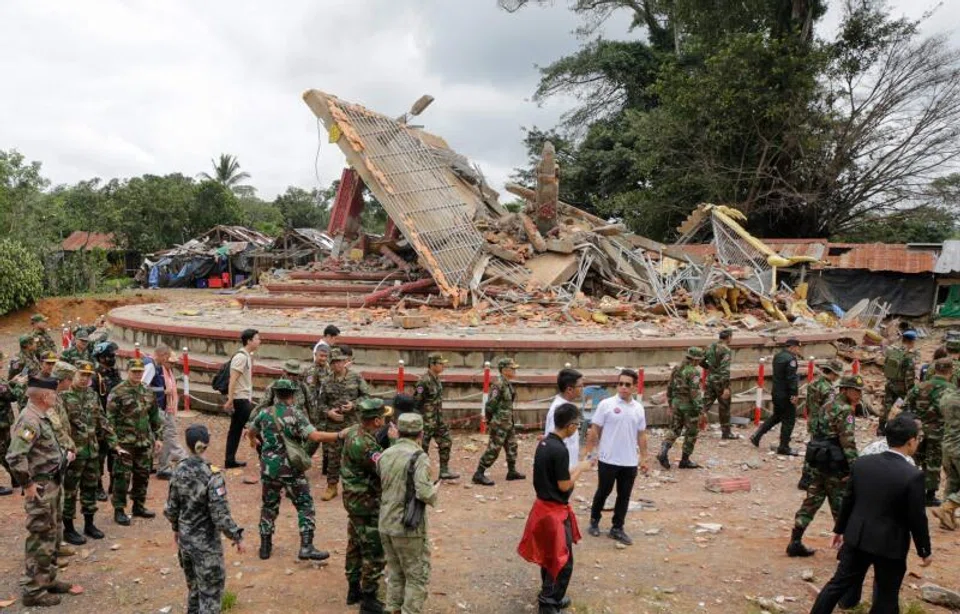 Military attaches and diplomats from 13 countries observe the implementation of the Cambodia–Thailand ceasefire agreement next to a destroyed building by the An Ses border checkpoint in Cambodia's Preah Vihear province.