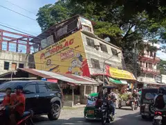 Motorists maneuvering next to a damaged building following an earthquake in Bangued, Abra province, Philippines, July 27, 2022. 