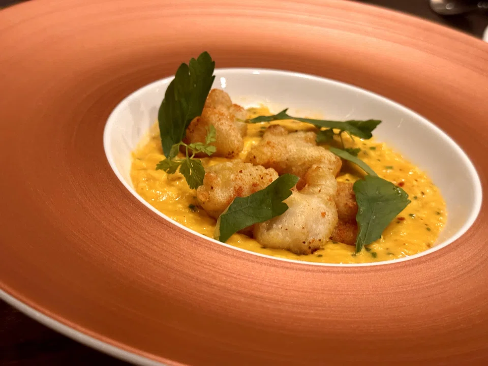 Frog legs tempura in a bed of creamy scrambled Japanese eggs.