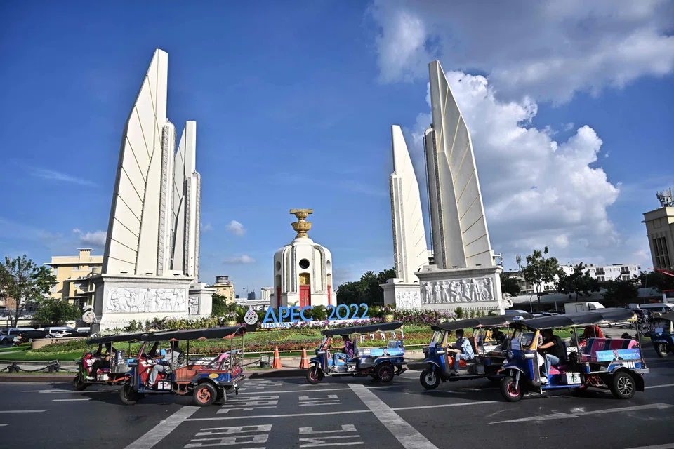 A group of tuk tuks pass by the Democracy Monument in Bangkok on Nov 15, 2022. Thailand is hosting the APEC Summit this week.