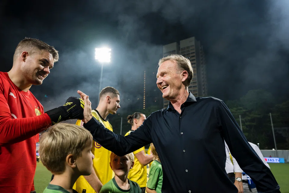 Borussia Dortmund CEO Hans-Joachim Watzke (in black) at the Jalan Besar Stadium on Nov 24, 2022 for his team's friendly match with the Lion City Sailors.