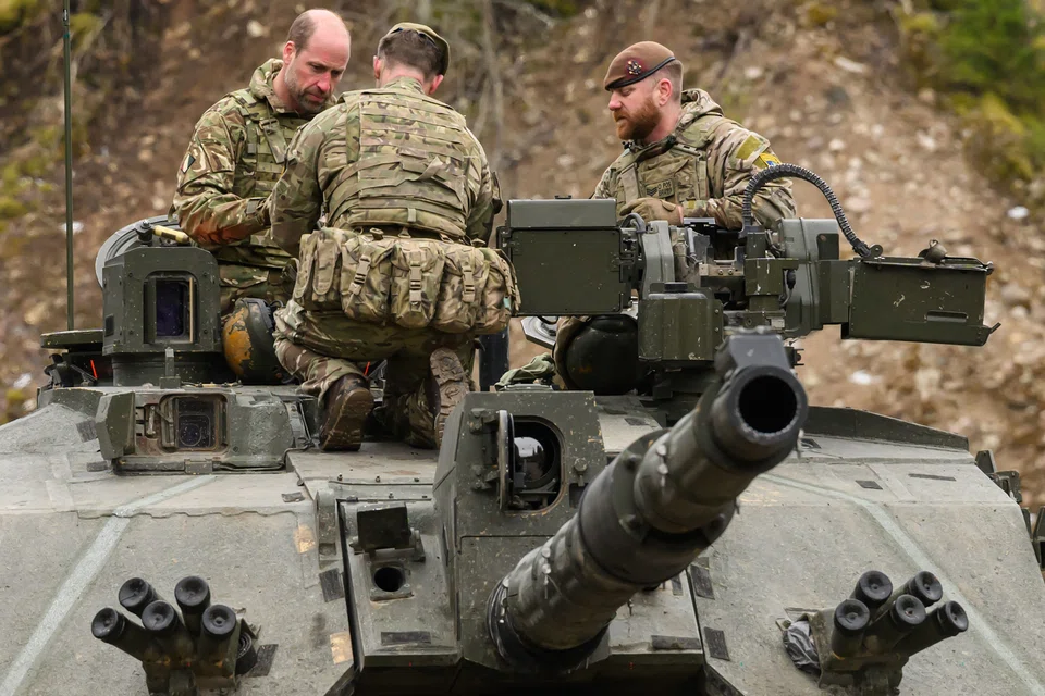 Britain's Prince William speaking to soldiers while visiting British service personnel at the Tapa Army Base, northern Estonia, in March. Unlike social expenditure, defence spending faces little political resistance. 