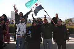 People celebrate after the fall of  President Bashar al-Assad in central Damascus, Syria, Dec 8, 2024. 