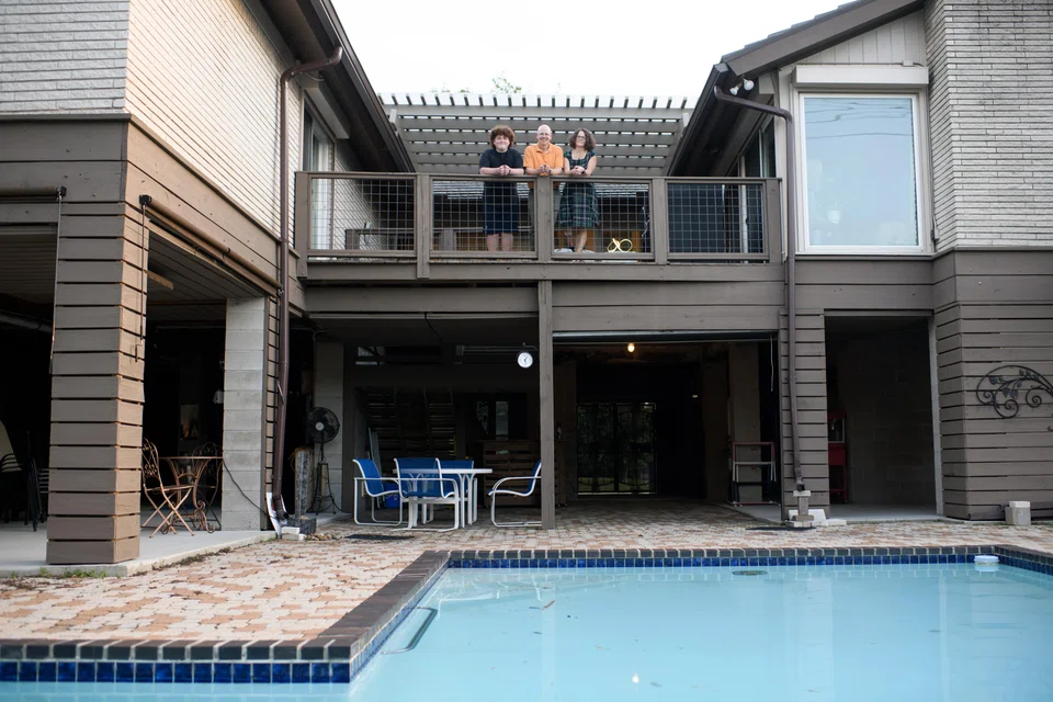 The Shefman family at their elevated home in Houston's bayou-hugging Meyerland neighbourhood; raising the house was a costly US$420,000.