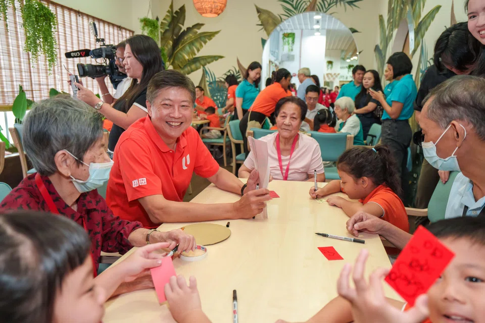 NTUC secretary-general Ng Chee Meng with children and seniors participating in one of the intergenerational activities supported by the NTUC Community Fund.