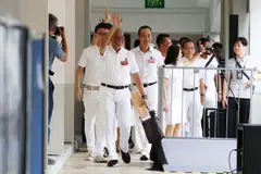 The PAP's Tampines GRC team arriving at Poi Ching School to submit their nomination papers. 