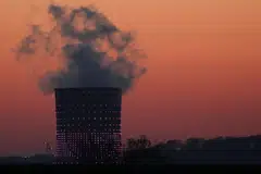 Smoke billows from a chimney at a combined-cycle gas turbine power plant in Drogenbos, Belgium April 27, 2021. 
