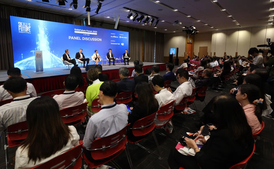 At  the forum. The panellists are from left: Tan Kok Yam, chief executive of SkillsFuture Singapore; Aslam Sardar, CEO of the Institute for Human Resource Professionals; Lee Hui Li, managing director of Microsoft Singapore; Lee Kian Chong, CEO of Deli in the Park; and moderator Christopher Lim, associate editor for product at The Business Times.