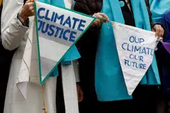 Supporters and members of the association Senior Women for Climate Protection hold banners as they arrive for the ruling in the climate case Verein KlimaSeniorinnen Schweiz and Others v. Switzerland, at the European Court of Human Rights (ECHR) in Strasbourg, France.