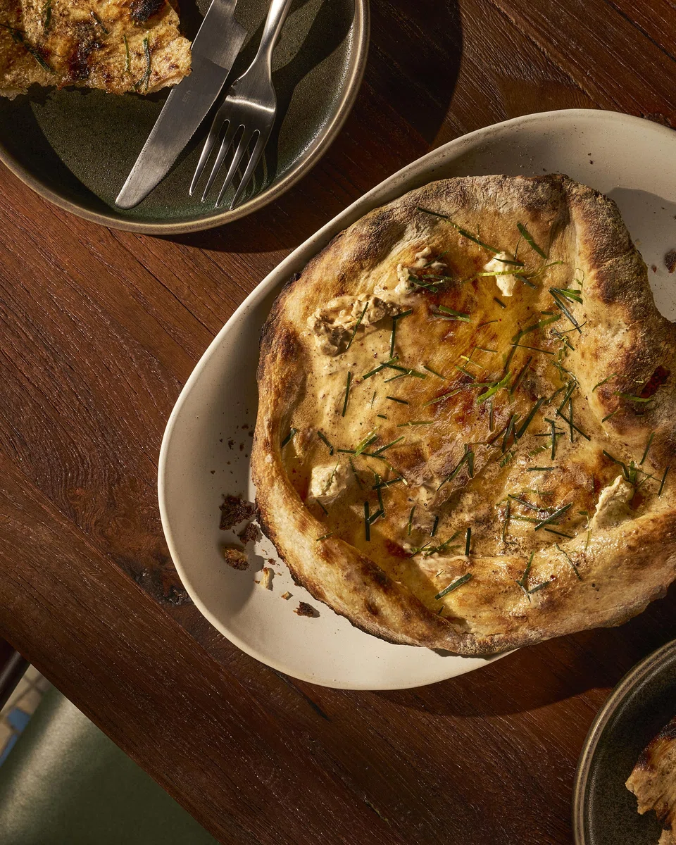 Tandoor bread is slathered with homemade savoury butter.