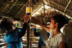 The volunteers installing the light and battery packs in the villagers’ homes.