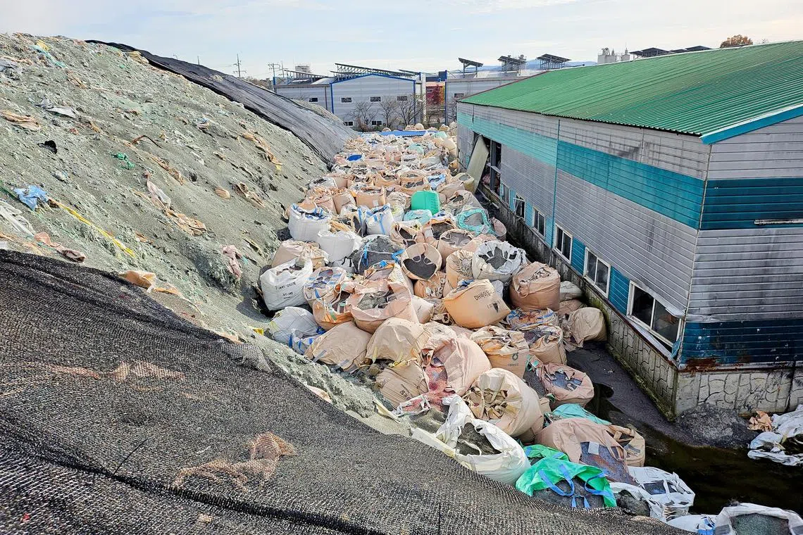 Sacks of untreated and shredded plastic waste, which is left unattended, are piled at an inoperational recycling site in Asan, South Korea, Nov 19, 2024.