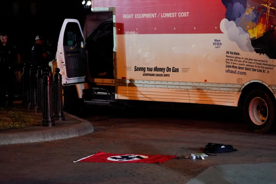 A Nazi flag and other objects recovered from a rented box truck are pictured as the US Secret Service and other law enforcement agencies investigate the truck that crashed into security barriers at Lafayette Park across from the White House in Washington, May 23, 2023.   