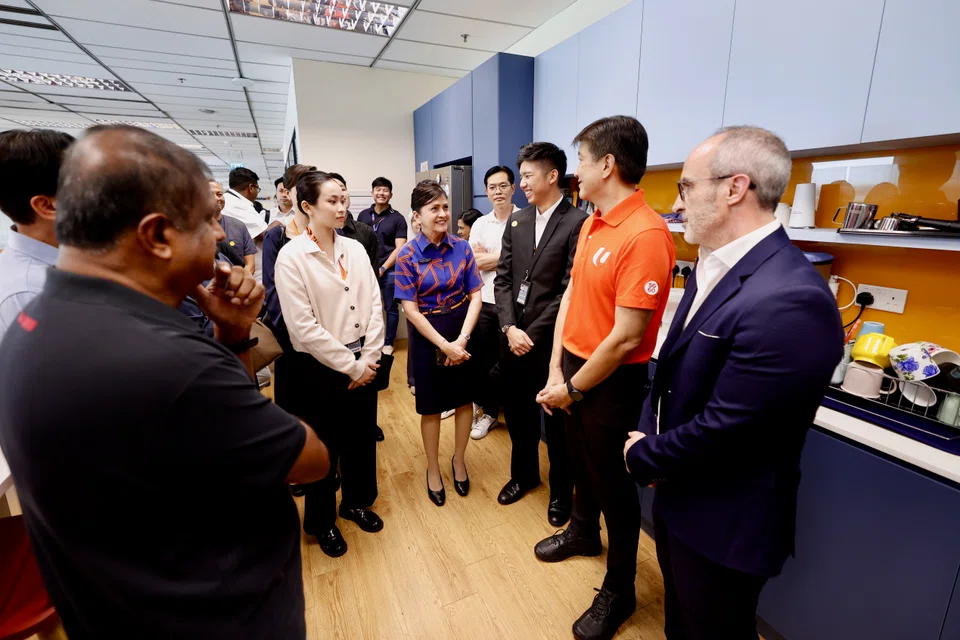 Labour chief Ng Chee Meng (second from right) says he met the affected Jetstar Asia workers at Terminal 1 on Wednesday, where they shared their concerns and uncertainties.