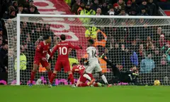 Manchester United's Amad Diallo (in white) scores the team's second goal past Liverpool's Alisson Becker, Liverpool, England, Jan 5, 2025. 