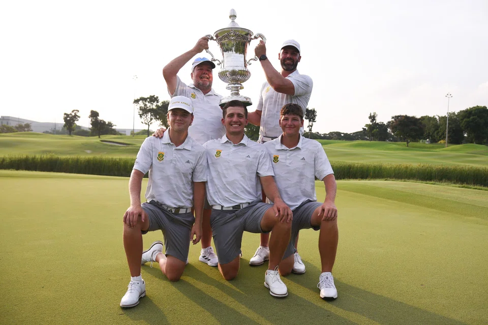 (Clockwise from bottom right) South Africa golfers Charl Barnard, Christiaan Maas and Daniel Bennett, coach Peet Van Schalkwyk and captain Gavin Groves pose with the Eisenhower Trophy.