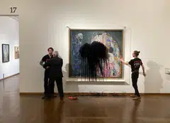 Florian Wagner, of the Last Generation group, is restrained while a fellow activist has glued himself to the painting Death and Life by Gustav Klimt after pouring black liquid over it, at the Leopold Museum in Vienna, Austria on Nov 15.