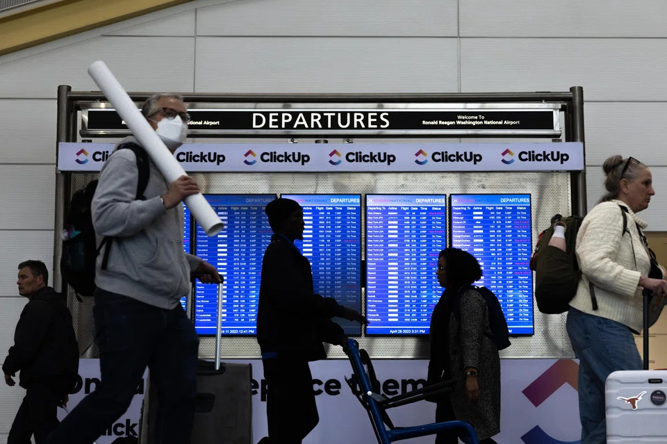 A masked traveller at Ronald Reagan Washington National Airport in Arlington, Virginia, April 28, 2023. While Covid-19 mandates and lockdowns are long gone, the virus isn't.