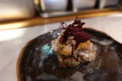 Dirty Supper’s signature fried chicken skin and smoked mackerel. 