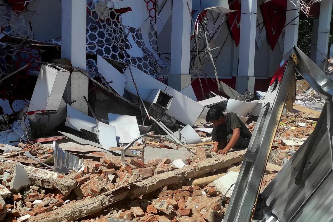 A man inspects debris at the site of a damaged building following an earthquake in Manado, North Sulawesi province, Indonesia, April 2, 2026. 