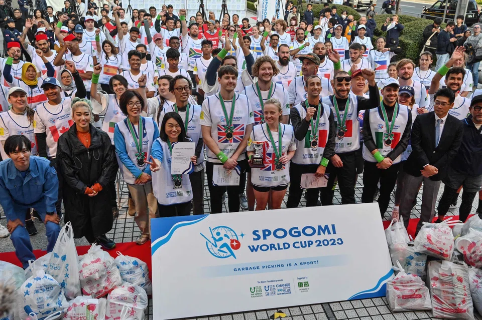 The winning teams and other participants of the inaugural SpoGomi World Cup 2023 in Tokyo on Nov 22. The contest involves teams from different countries picking up as much rubbish as possible within a time limit.