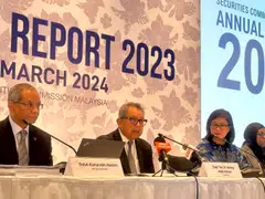 Securities Commission executive chairman Awang Adek (centre) says total funds raised in Malaysia’s capital market moderated to RM127.7 billion last year.