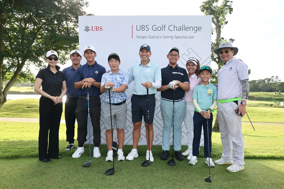Sergio Garcia (fifth from left) with young golfers from Tanah Merah Country Club. With them is Patricia Quek, head of UBS Wealth Management Singapore (far left).