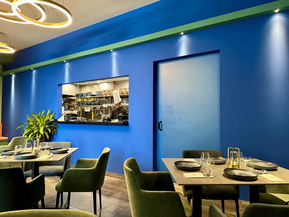 Akasa's cheerful blue interiors help the restaurant evoke a cosy atmosphere.